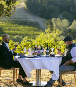 Carlton McCoy and Matt Taylor around table in vineyard wiht Ink Grade Howell Mountain WInes