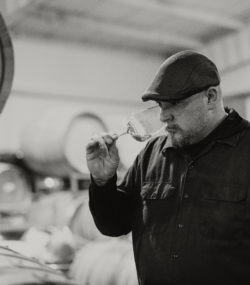 Winemaker Matt Taylor smells a glass of white wine in the cellar