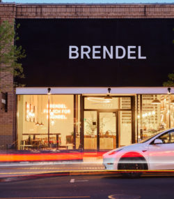 Exterior of brendel tasting room on main st Napa with white car passing in front