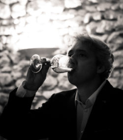 Winemaker Florian Mollet tastes white wine in the cellar