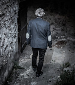 Winemaker Florian Mollet descends stairs into Roc de l'Abbaye cellar