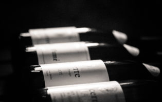 Stylized photo of Domaine Roc de l'Abbaye bottles, black and white